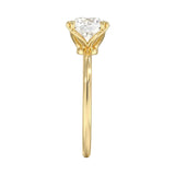 Symmetrical top-down view of a round moissanite solitaire in a secure yellow gold setting.