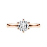 Close-up of a D-color VVS1 round moissanite held by six elegant, sophisticated gold prongs.