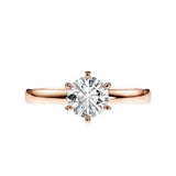 Close-up of a D-color VVS1 round moissanite held by six elegant, sophisticated gold prongs.