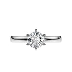 Close-up of a D-color VVS1 round moissanite held by six elegant, sophisticated gold prongs.