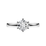 Close-up of a D-color VVS1 round moissanite held by six elegant, sophisticated gold prongs.