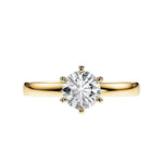 Close-up of a D-color VVS1 round moissanite held by six elegant, sophisticated gold prongs.