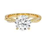Four-claw cat-claw round brilliant moissanite ring with a single pavé vine twist band in yellow gold ApolloGem.