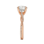Top-down view of a D-color VVS1 round stone in an asymmetrical rose gold cat-claw setting.