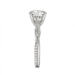 Top-down view of a D-color VVS1 round stone in an asymmetrical white gold cat-claw setting.