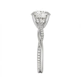 Top-down view of a D-color VVS1 round stone in an asymmetrical white gold cat-claw setting.