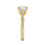 Top-down view of a D-color VVS1 round stone in an asymmetrical yellow gold cat-claw setting.