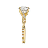 Top-down view of a D-color VVS1 round stone in an asymmetrical yellow gold cat-claw setting.