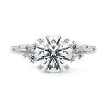 Unique bridal stack featuring a round stellar moissanite ring paired with a matching gold wedding band for a high-glamour look.