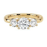 Classic round brilliant moissanite trilogy engagement ring in yellow gold ApolloGem.
