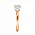 Symmetrical top-down view of a graduated three-stone round moissanite ring in polished solid gold.