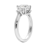 Detailed side view showing the architectural four-prong basket settings for the three-stone moissanite ring.
