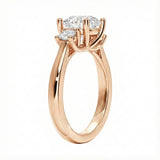 Detailed side view showing the architectural four-prong basket settings for the three-stone moissanite ring.