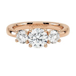 Classic round brilliant moissanite trilogy engagement ring in rose gold ApolloGem.