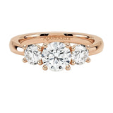 Classic round brilliant moissanite trilogy engagement ring in rose gold ApolloGem.