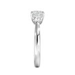Symmetrical top-down view of a graduated three-stone round moissanite ring in polished solid gold.