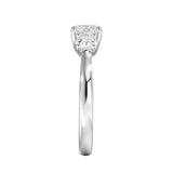 Symmetrical top-down view of a graduated three-stone round moissanite ring in polished solid gold.
