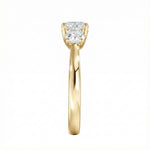 Symmetrical top-down view of a graduated three-stone round moissanite ring in polished solid gold.