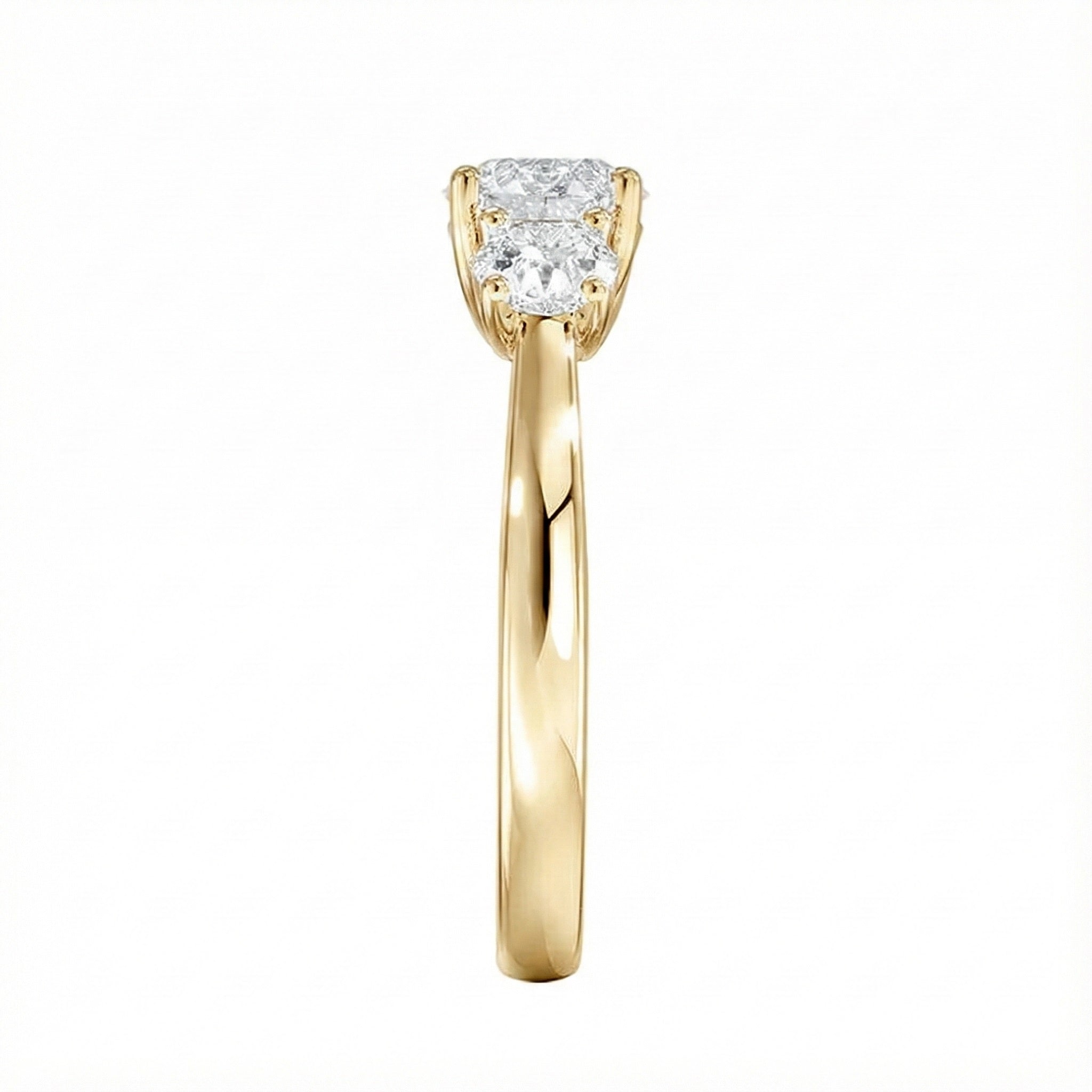 Symmetrical top-down view of a graduated three-stone round moissanite ring in polished solid gold.