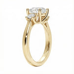 Detailed side view showing the architectural four-prong basket settings for the three-stone moissanite ring.