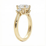 Detailed side view showing the architectural four-prong basket settings for the three-stone moissanite ring.