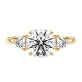 Luxury round brilliant moissanite engagement ring in yellow gold featuring structural trillion cut side stones ApolloGem South Africa.
