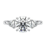 Close-up of a high-quality GRI certified D-color VVS1 round brilliant moissanite with sharp trillion side stones.