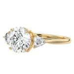 Detailed side view of a round moissanite ring showing the secure setting and geometric trillion-shaped side accents