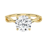 Round brilliant moissanite engagement ring with a twisted infinity-style yellow gold band ApolloGem.