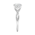 Symmetrical top-down view of a round moissanite solitaire on a decorative twisted gold band.