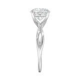 Symmetrical top-down view of a round moissanite solitaire on a decorative twisted gold band.