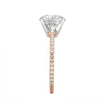 Top-down view of a D-color VVS1 round brilliant moissanite in a rose gold solitaire setting.