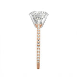 Top-down view of a D-color VVS1 round brilliant moissanite in a rose gold solitaire setting.
