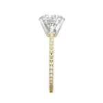 Top-down view of a D-color VVS1 round brilliant moissanite in a yellow gold solitaire setting.