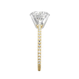 Top-down view of a D-color VVS1 round brilliant moissanite in a yellow gold solitaire setting.