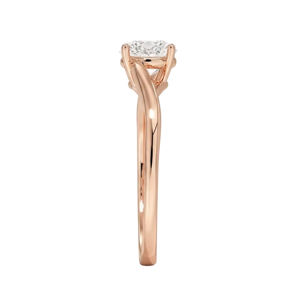 Round cut Twisted Shank Moissanite lab grown diamond engagement ring round shank with a four claw setting, on a gold band, against a white background.Moissanite engagement ring cape town south africa grand diamonds ralph jacobs jeuli