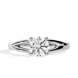 Close-up of a D-color VVS1 round moissanite held by elegant, sophisticated pin-claws.