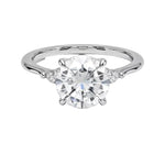 Round brilliant moissanite engagement ring with pear cut side stones white gold