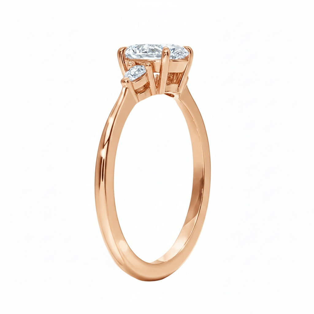 Rose gold ring with three diamonds on a white background
