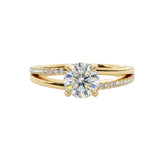 Dainty four-claw round brilliant moissanite ring on an asymmetric V-shape wishbone yellow gold band ApolloGem.