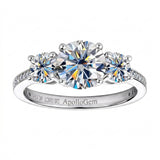 Three-stone moissanite trilogy engagement ring with round brilliant diamonds and a pavé band, handcrafted by ApolloGem South Africa.