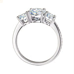 Three-stone round brilliant engagement ring with a shimmering pavé shank and GRI certified stones.