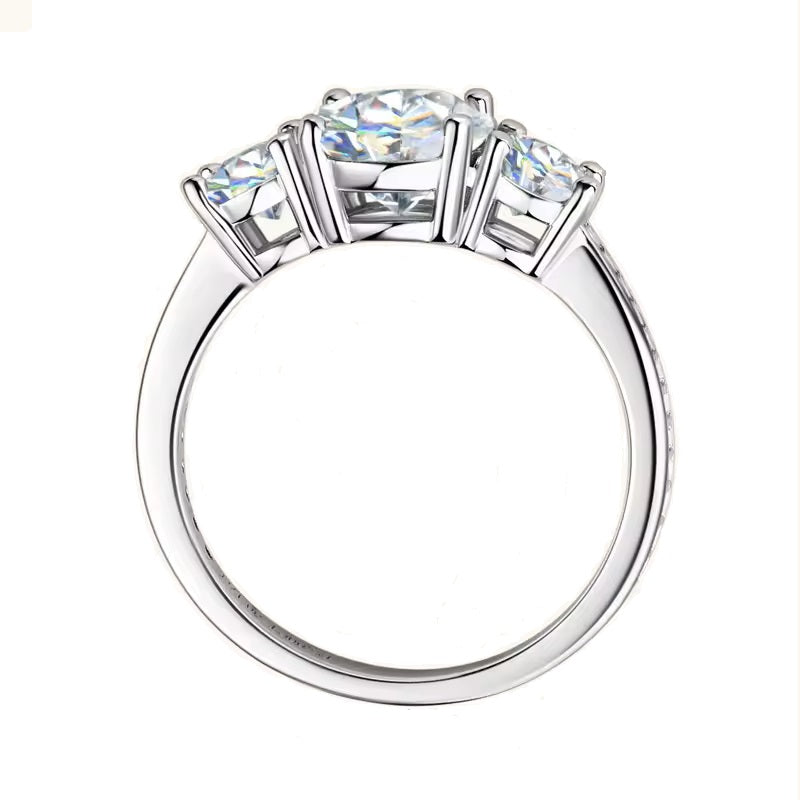 Three-stone round brilliant engagement ring with a shimmering pavé shank and GRI certified stones.