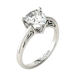Side profile of the Royal Solitaire ring showing the intricate sculpted scrolls and refined shared-prong integration