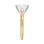 Detailed side view of a two-tone ring showing the yellow gold band and white gold six-prong crown setting.