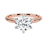 Close-up of a D-color VVS1 round moissanite in rose gold prongs to prevent yellow metal reflection.